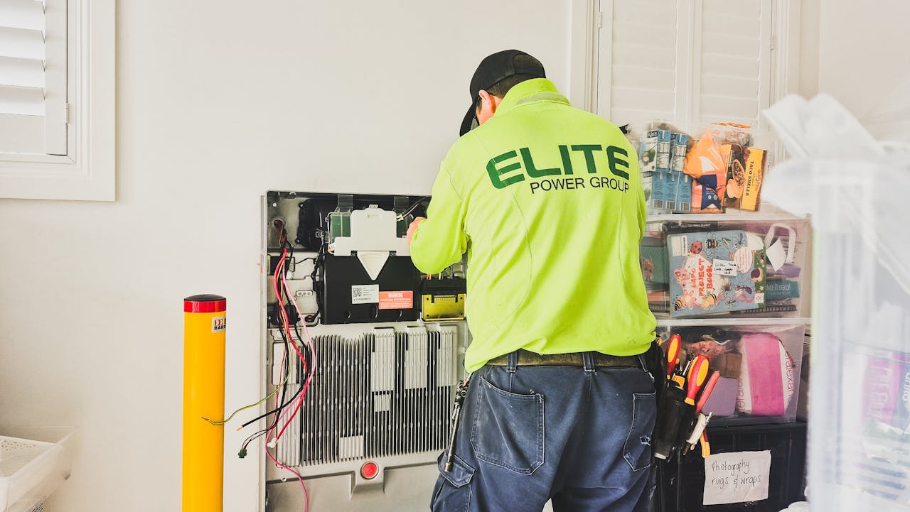 heros-img A technician from Elite Power Group installing a home battery system indoors in New South Wales, Australia.